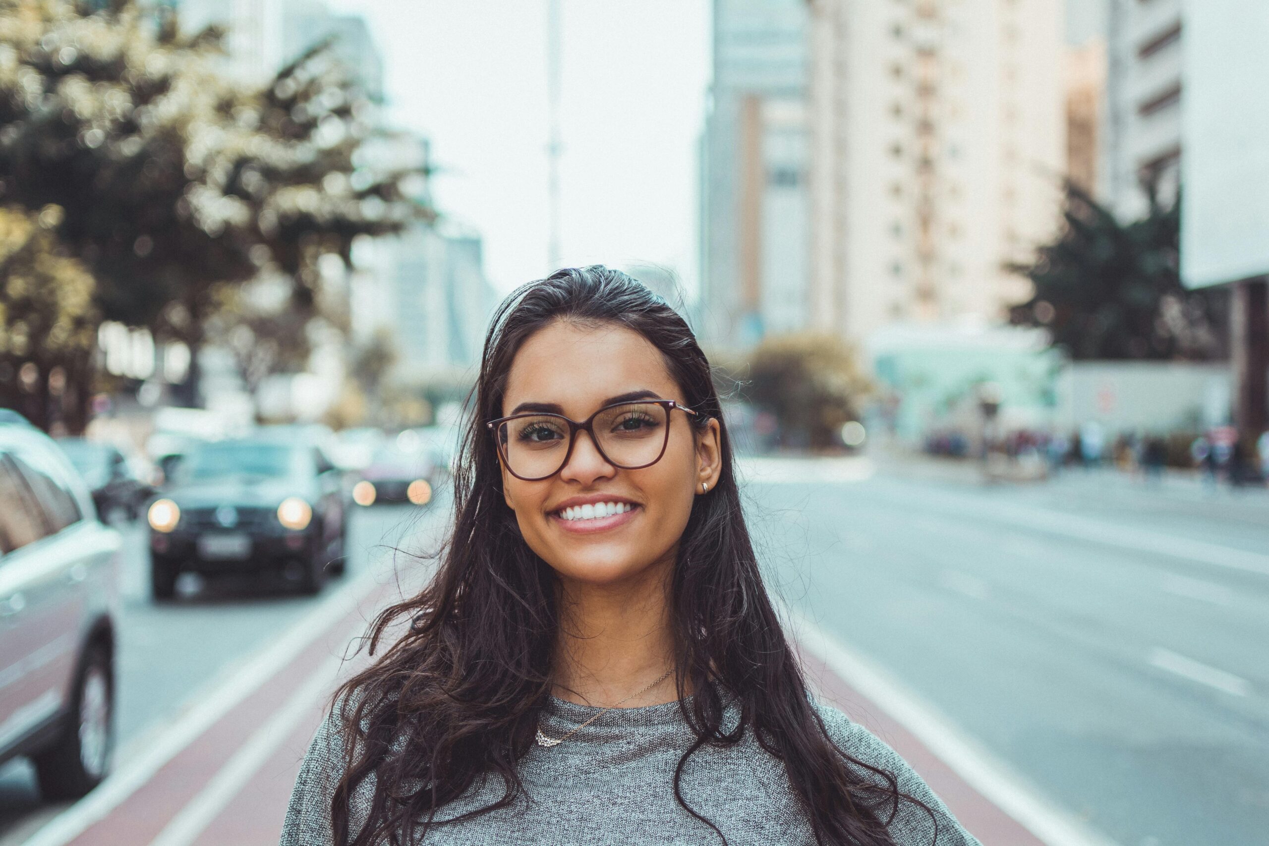 A woman smiling after adopting stress relief strategies