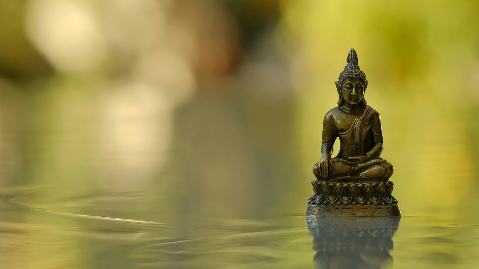 Woman sitting cross-legged on a mat practicing meditation