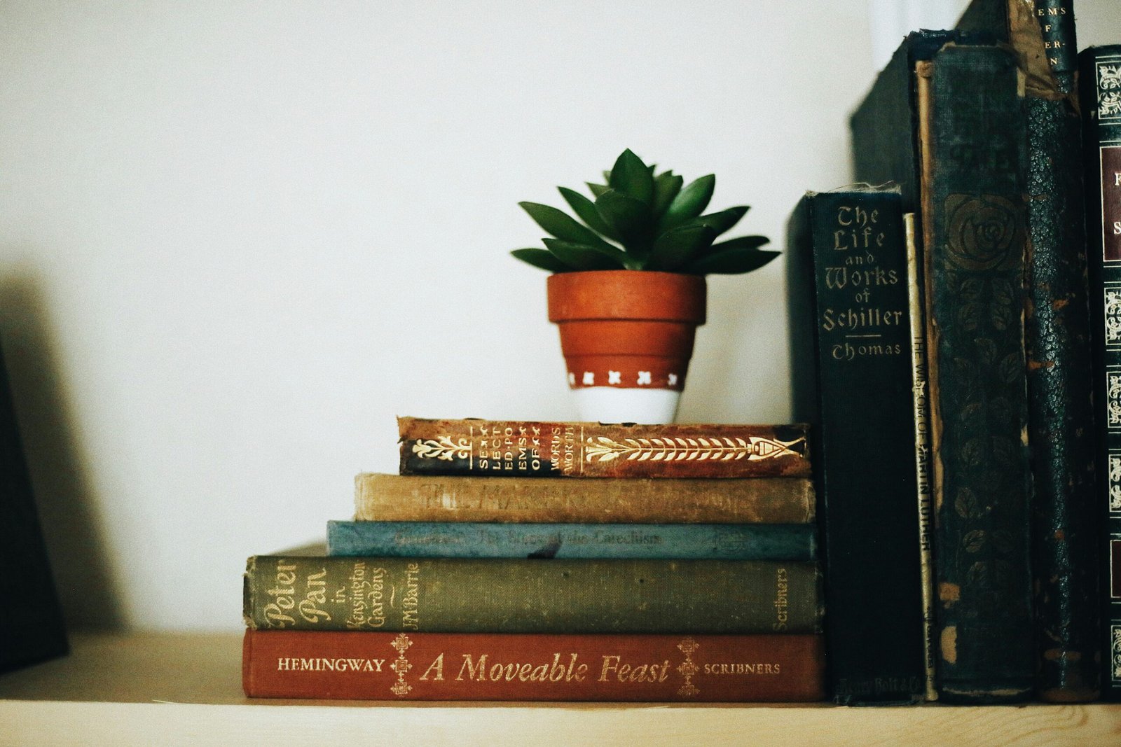 Photo of a cozy corner with candles, books, and plants