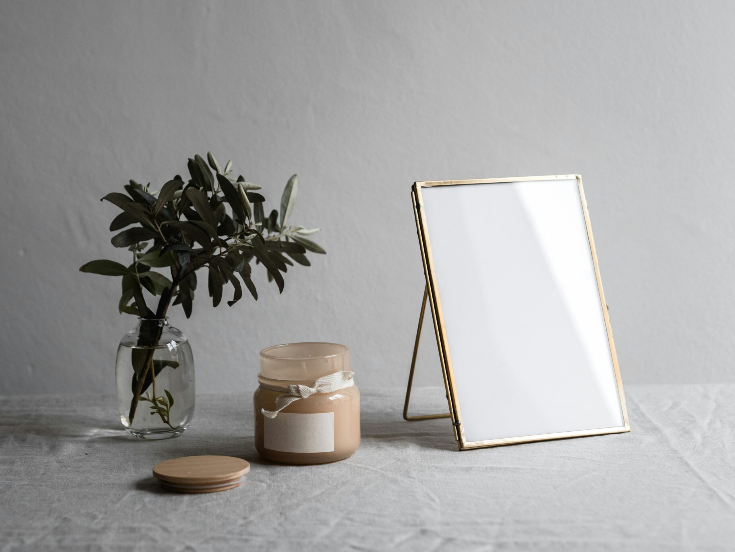 Photo of a serene home setup featuring a chair, plant, and candle