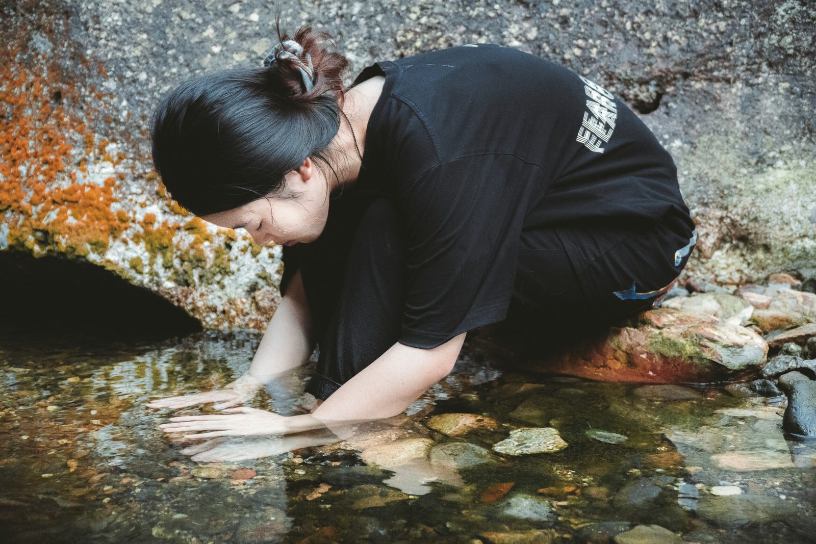 A cozy corner of a room with candles, books, and plants