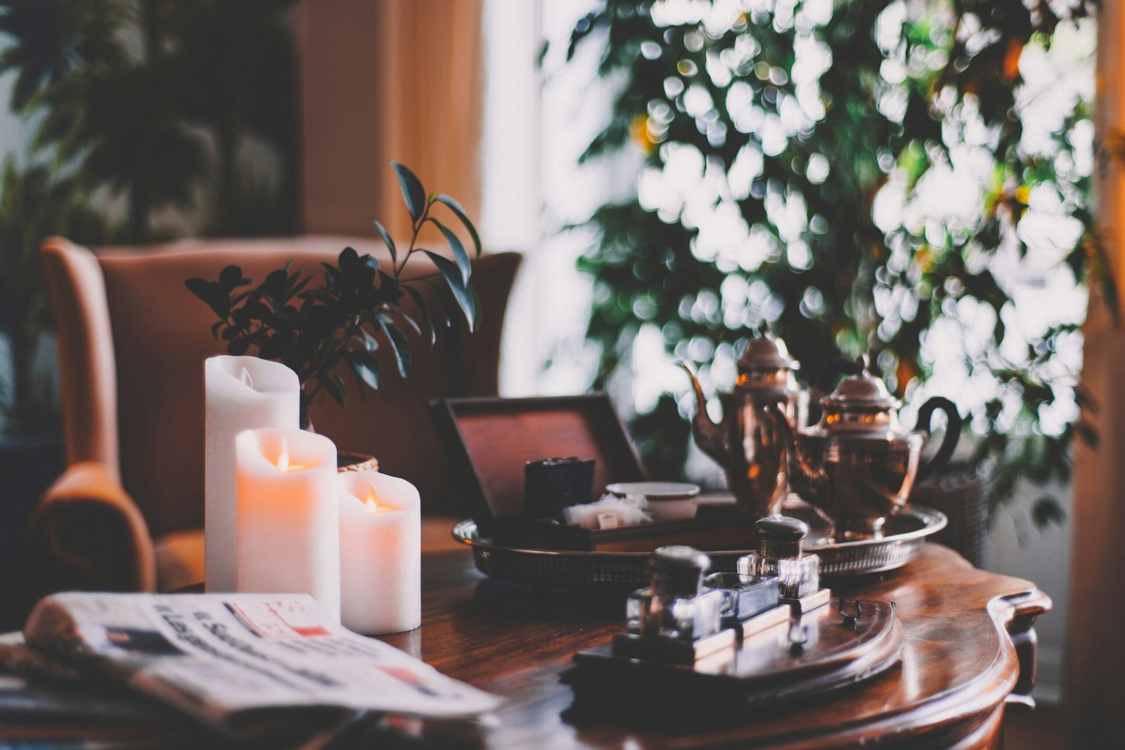 A cozy room setup with candles, plants, and books for mindfulness practices.