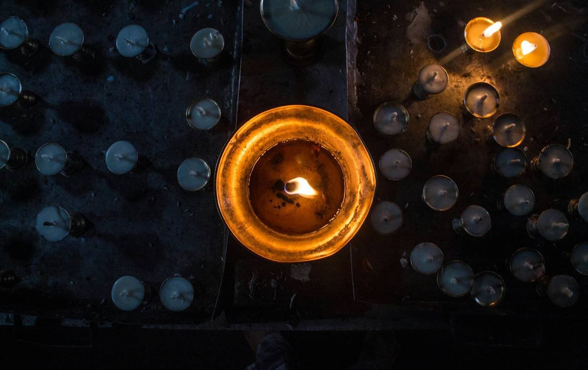 Person sitting cross-legged with eyes closed, hands resting on knees
