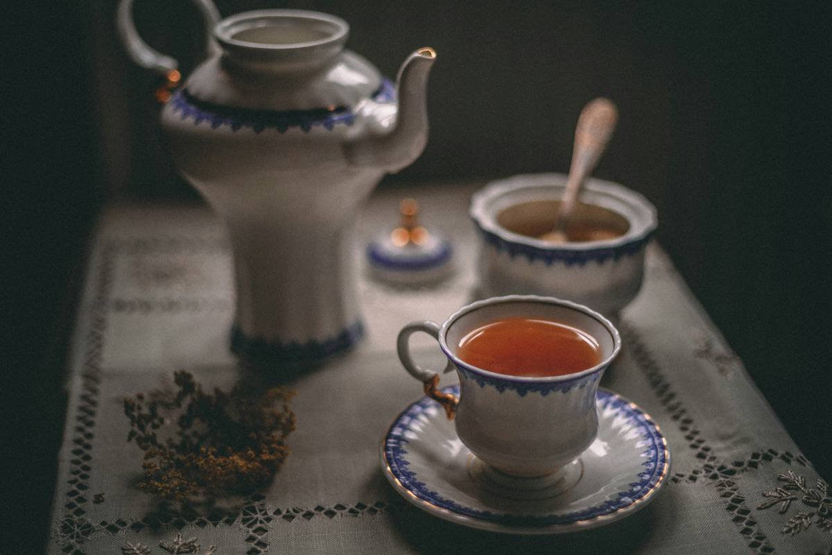 A person enjoying a zen tea ritual in a cozy home setting