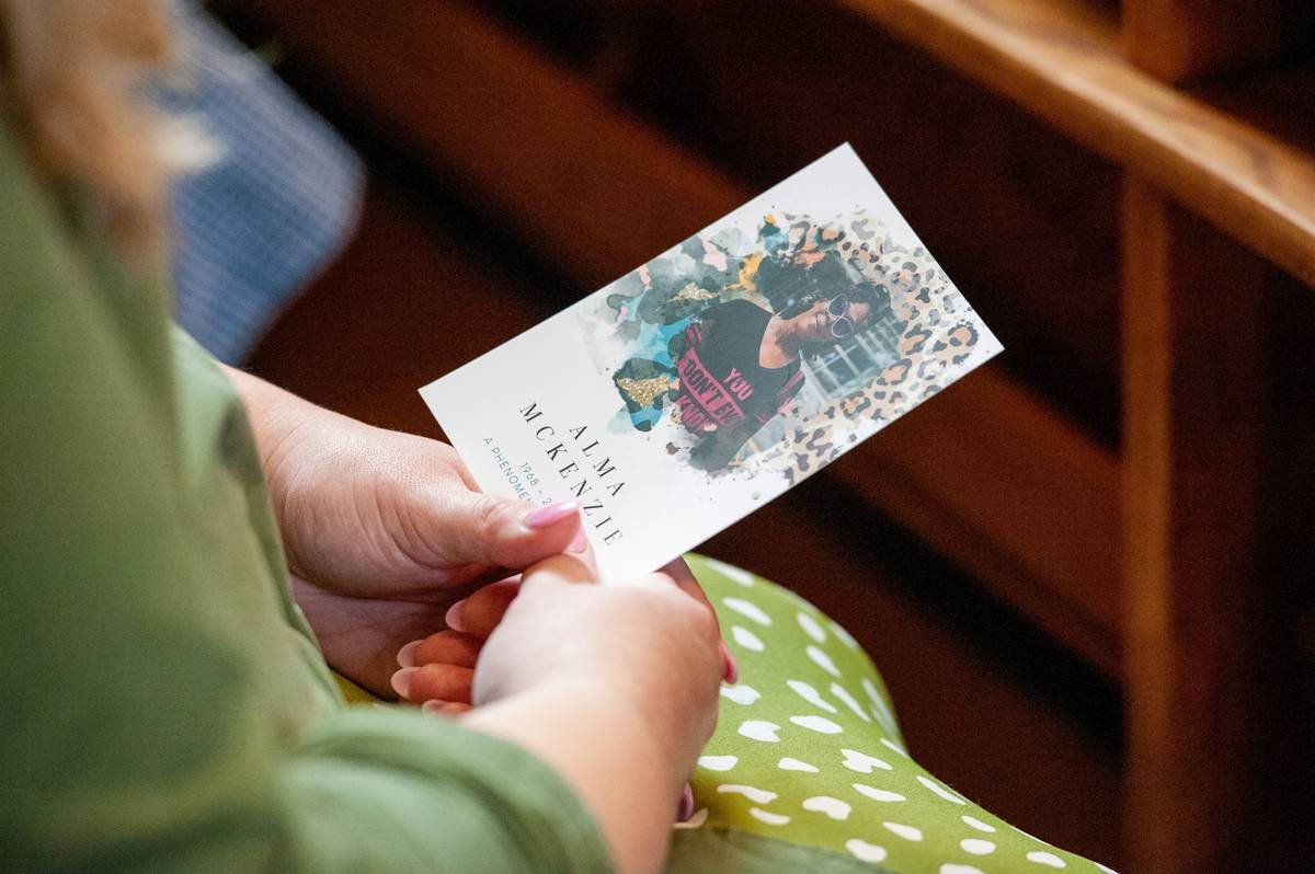 A serene woman meditating by a lake at sunrise